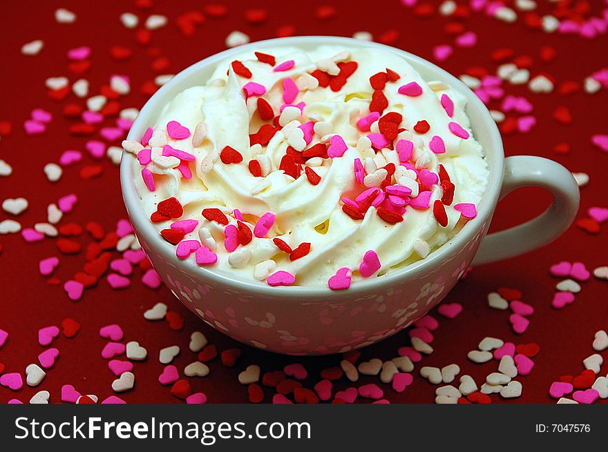 Hot cocoa with whipped cream and heart sprinkles. Hot cocoa with whipped cream and heart sprinkles