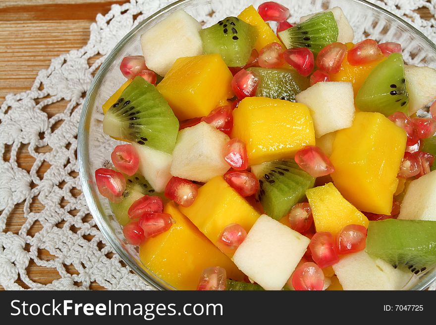 Fruit salad with kiwi, mango, pear and pomegranate. Fruit salad with kiwi, mango, pear and pomegranate