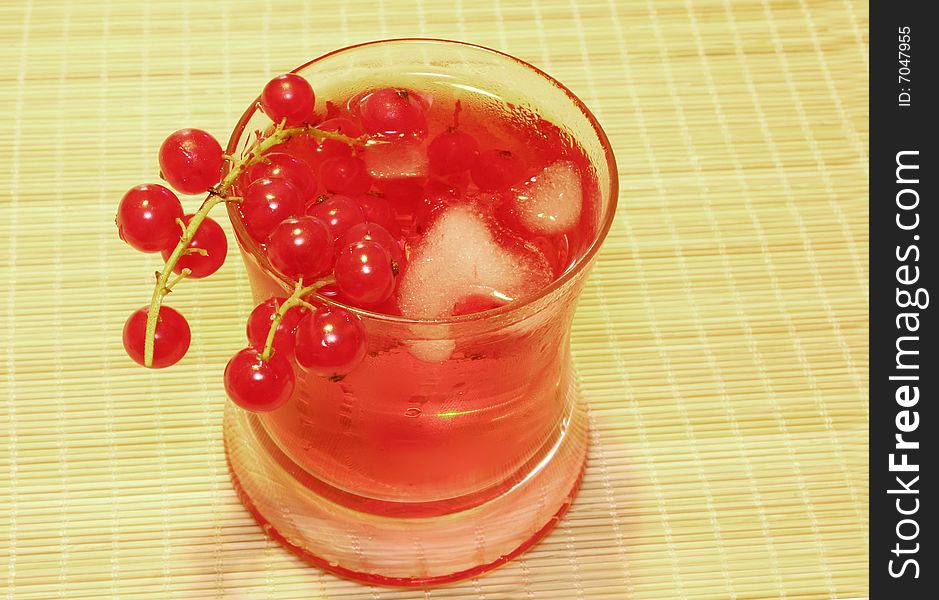 Cocktail decorated with red currant and ice