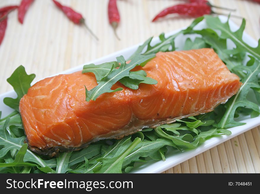 A snack of fresh salmon fish with salad