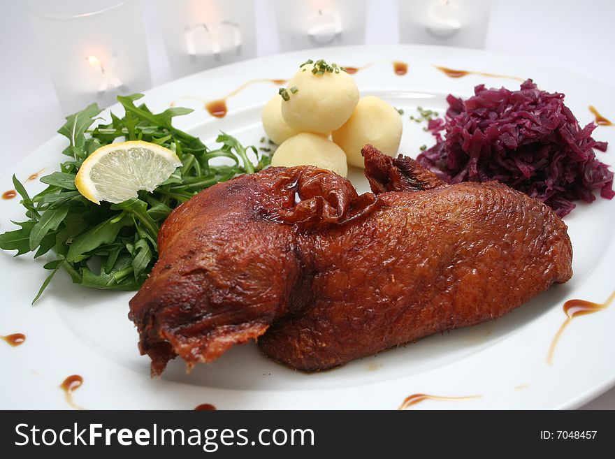 A meal of duck-meat with potatoes and red cabbage