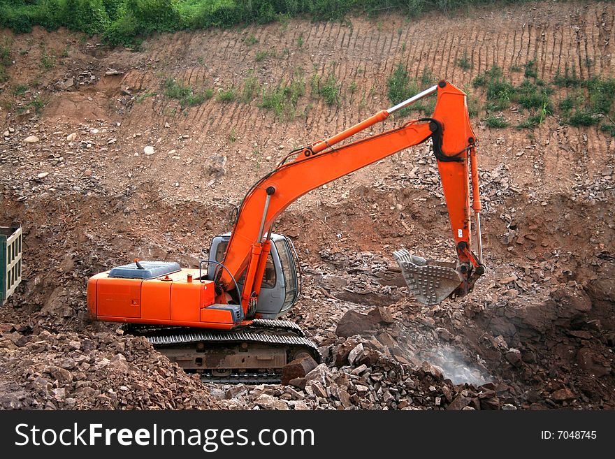 Orange excavator at construction site