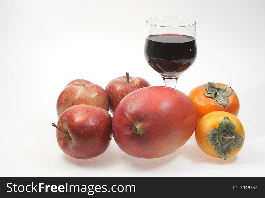 Goblet of red wine with fruits on white background. Goblet of red wine with fruits on white background