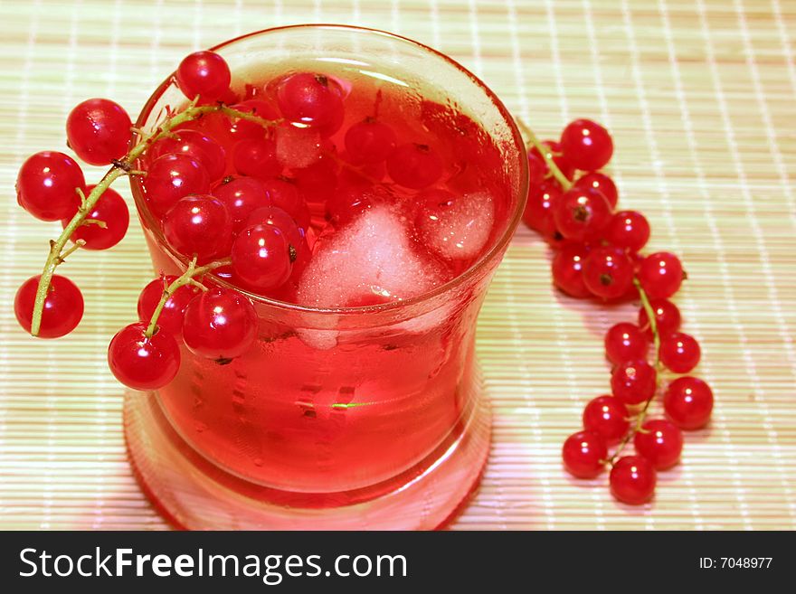 Cocktail decorated with red currant and ice