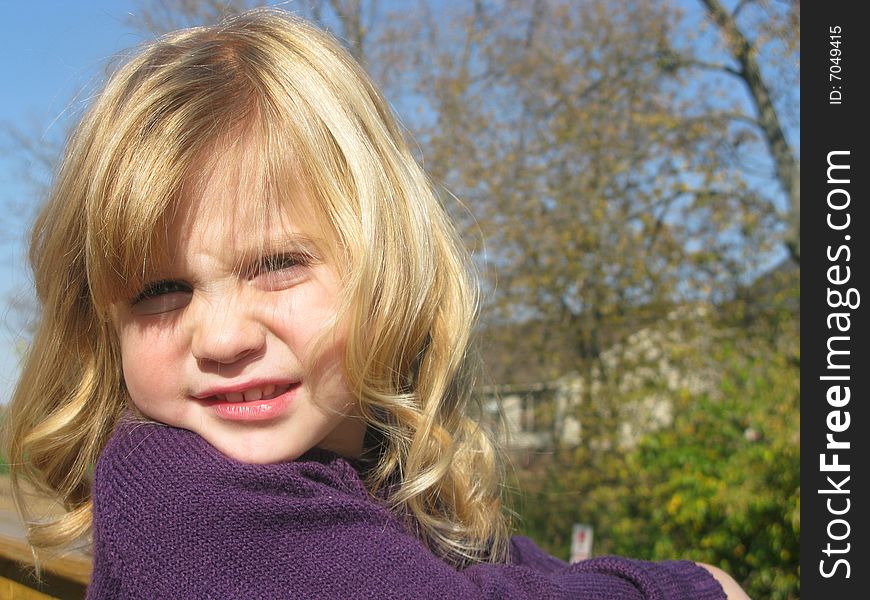 Closeup shot of a beautiful little girl playing outdoors. Closeup shot of a beautiful little girl playing outdoors.