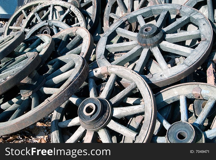 Pile of old wooden cartwheels. Pile of old wooden cartwheels