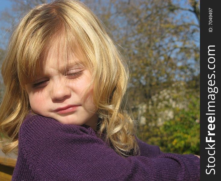 Closeup shot of a beautiful little girl playing outdoors. Closeup shot of a beautiful little girl playing outdoors.