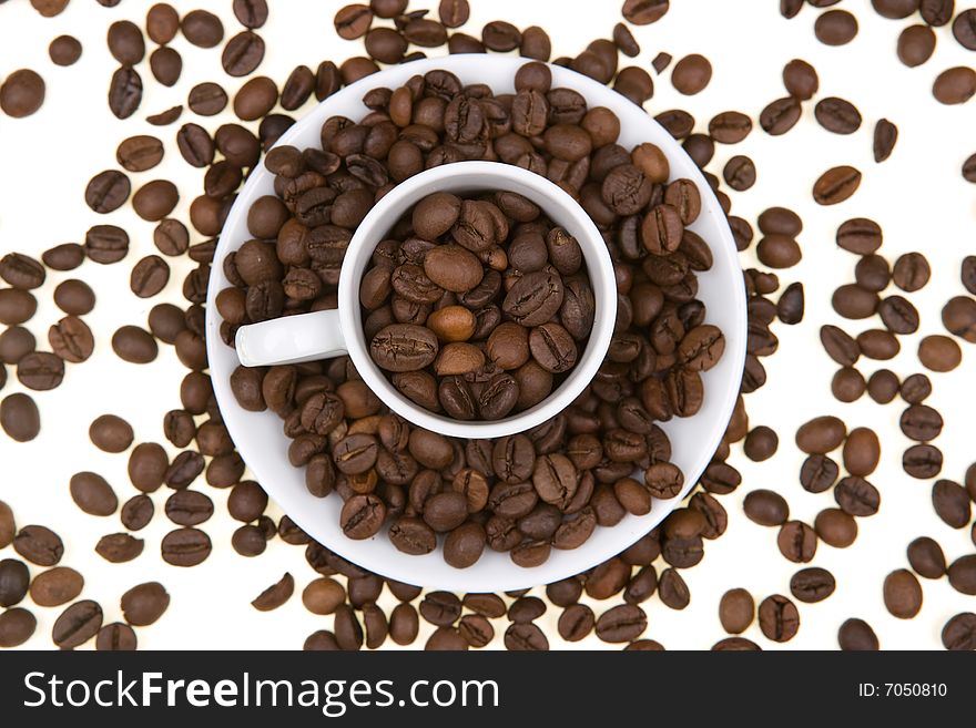 Background with white mug full of coffee beans. landscape orientation.