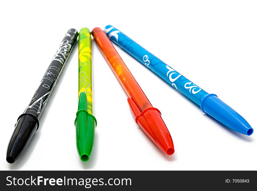 Set of four ballpoints against a white background