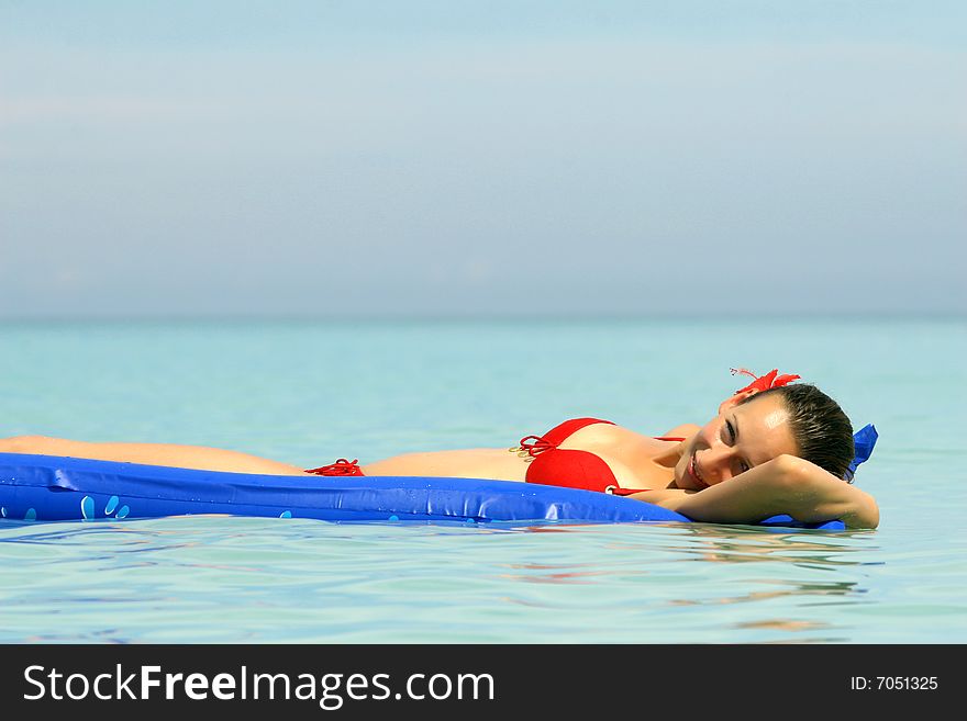 Woman Lying On An Air Mattress in ocean. Woman Lying On An Air Mattress in ocean