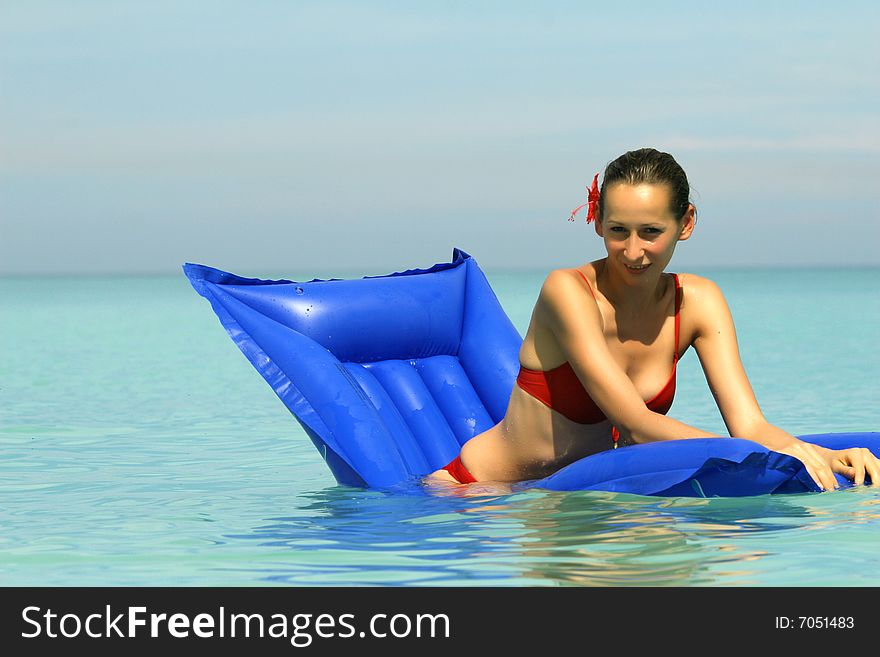 Woman swimming On An Air Mattress in ocean. Woman swimming On An Air Mattress in ocean