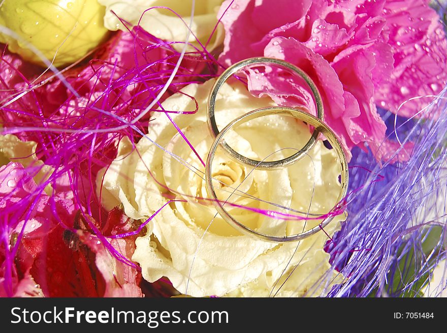 Two wedding rings made of white gold on the bright bouquet. Two wedding rings made of white gold on the bright bouquet