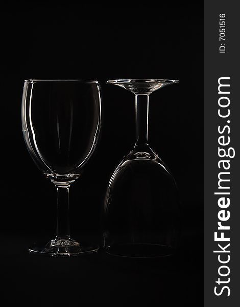 Two Empty wine glasses isolated on black background. Two Empty wine glasses isolated on black background.