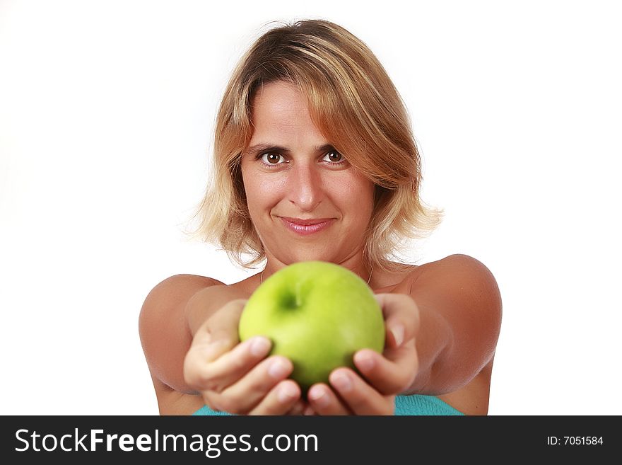 Portrait of a young beautiful woman holding a green apple
