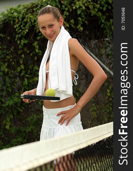 Woman in white skirt holding tennis racket outdoor. Woman in white skirt holding tennis racket outdoor