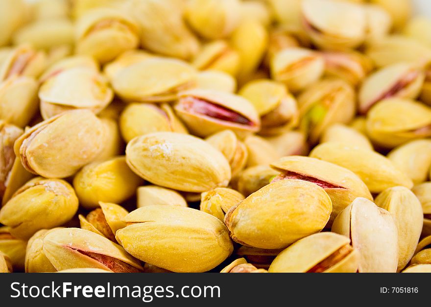 Delicious fresh pistachios background closeup