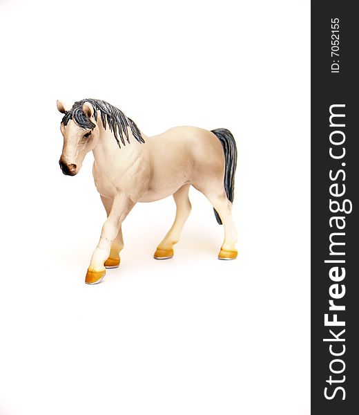 Close up of the plastic toy horse isolated on white background. Close up of the plastic toy horse isolated on white background.