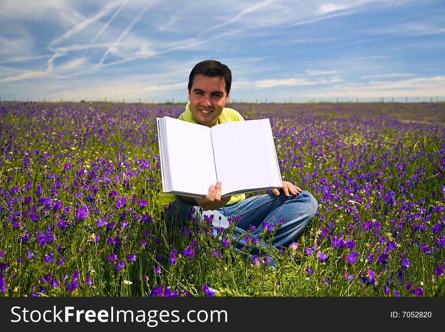 Young Man in a flied Holding Open Book with Blank Pages