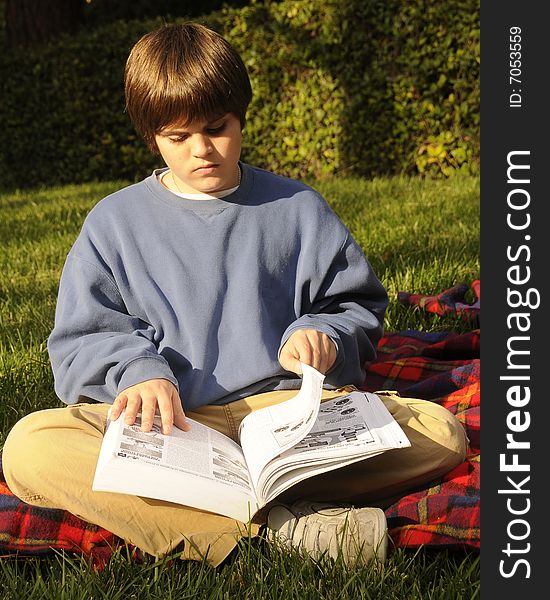 Young man reading manual for homework