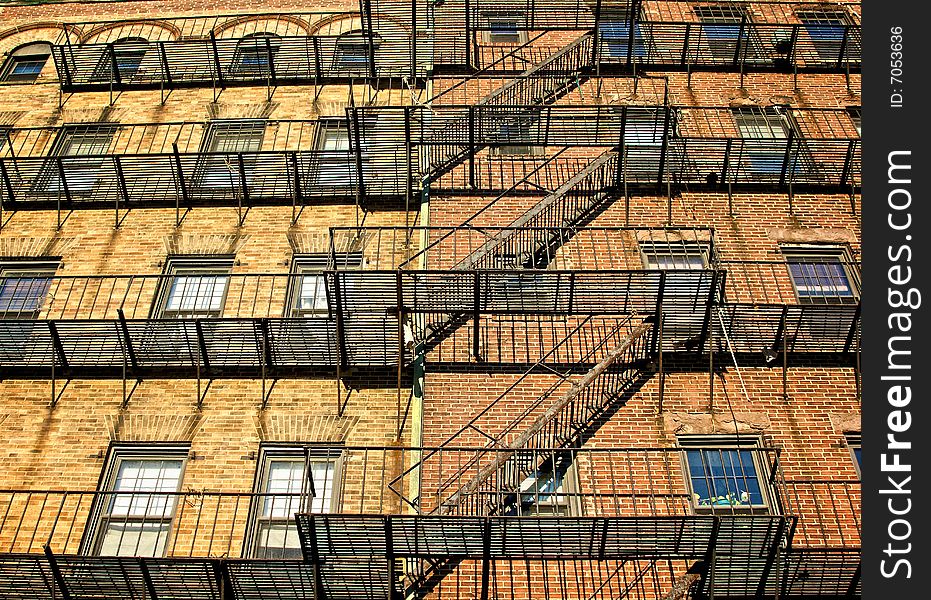 Fire escapes on old tenament buildings in boston massachusetts against a blue sky. Fire escapes on old tenament buildings in boston massachusetts against a blue sky