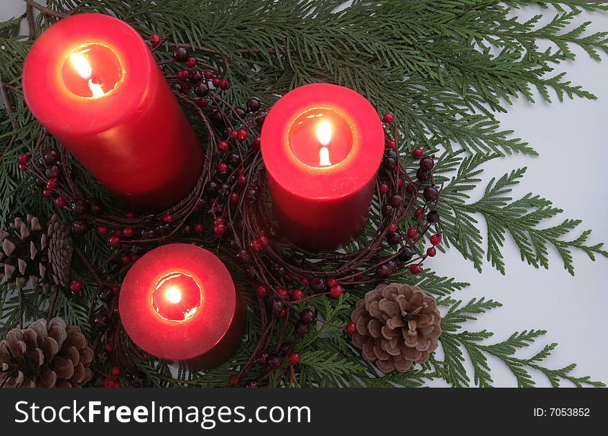 Three red candles in a christmas centerpiece. Three red candles in a christmas centerpiece