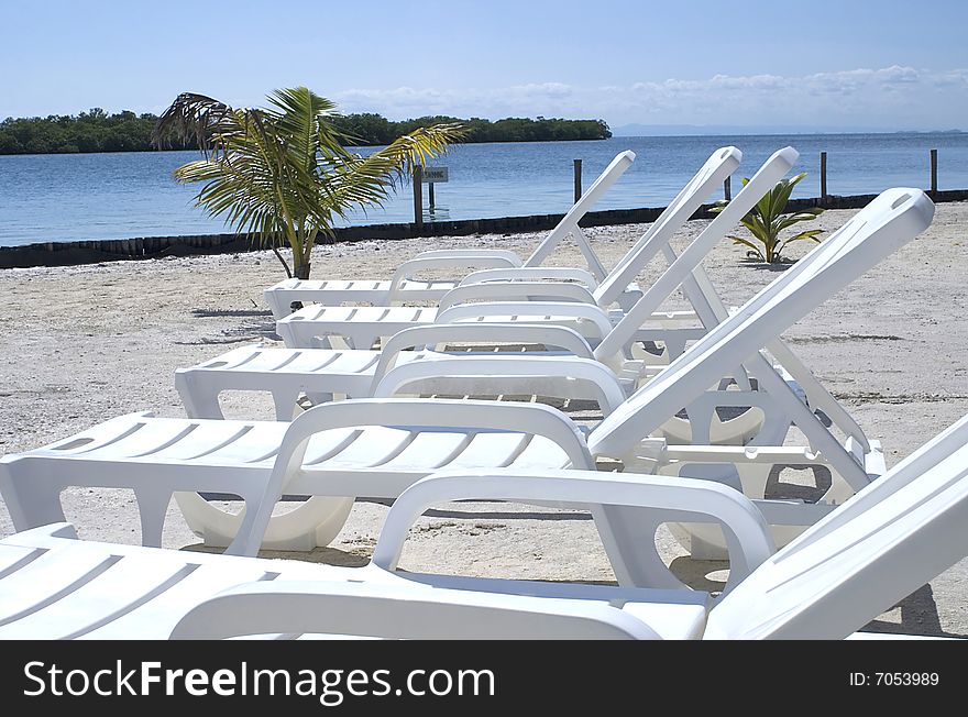 Line of chairs on the water.