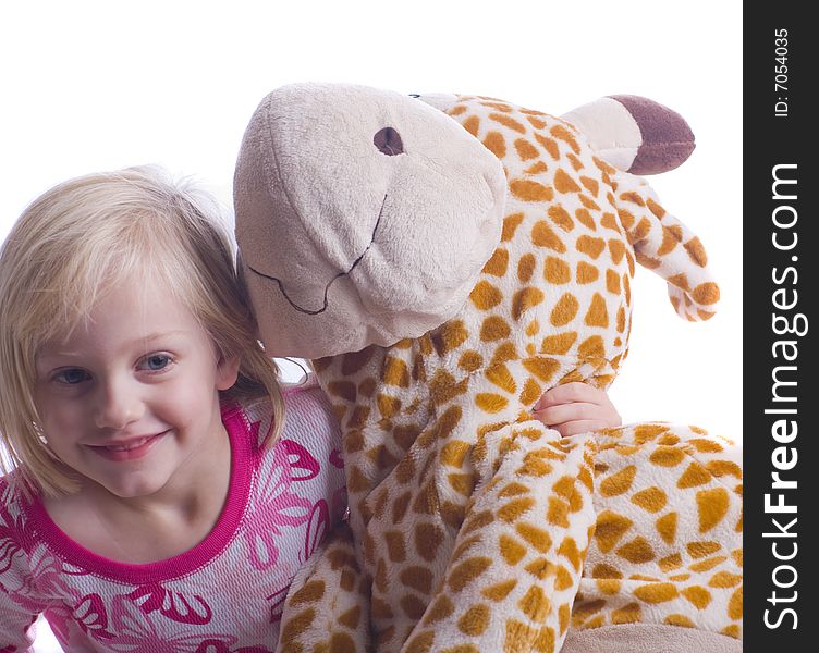 Child with stuffed giraffe in pajamas ready for bed. Child with stuffed giraffe in pajamas ready for bed