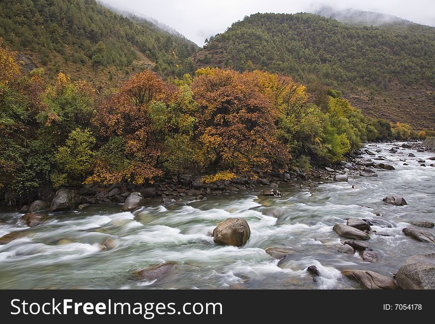 River flows in the mountains in autumn in the southwest of china. River flows in the mountains in autumn in the southwest of china