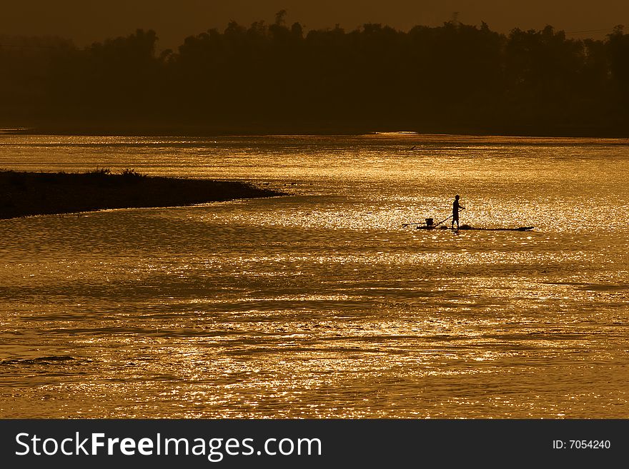 A fisherman with boat on sunset