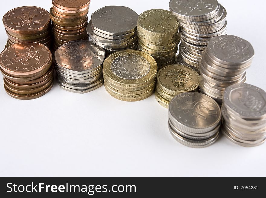 Random piles of used UK coins with copy space