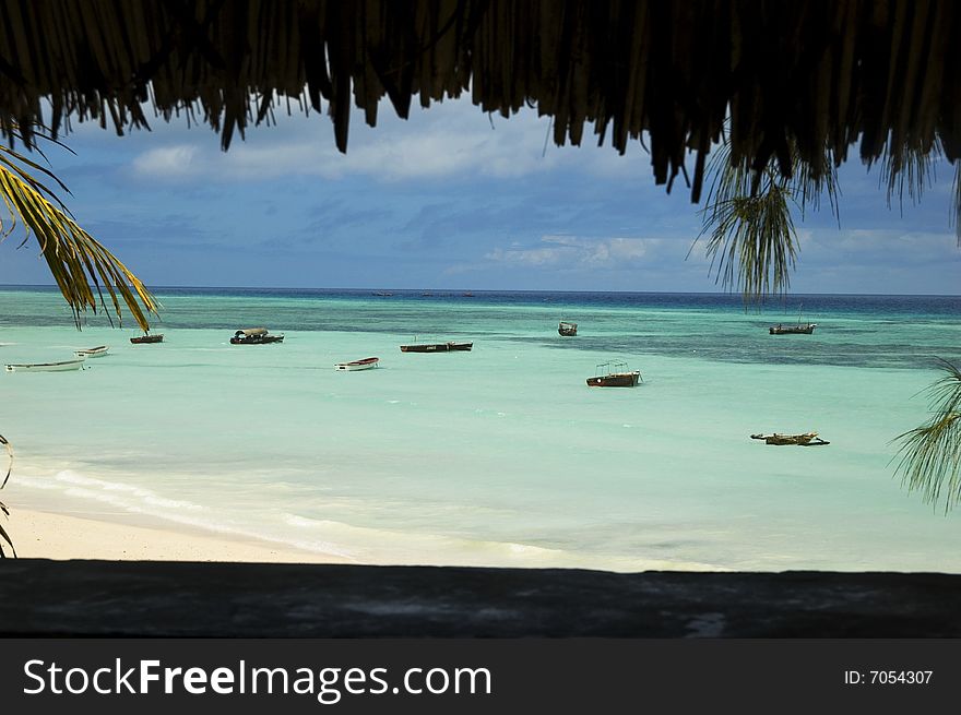 Picture taken from hut of beach and anchored boats of the coast of Africa