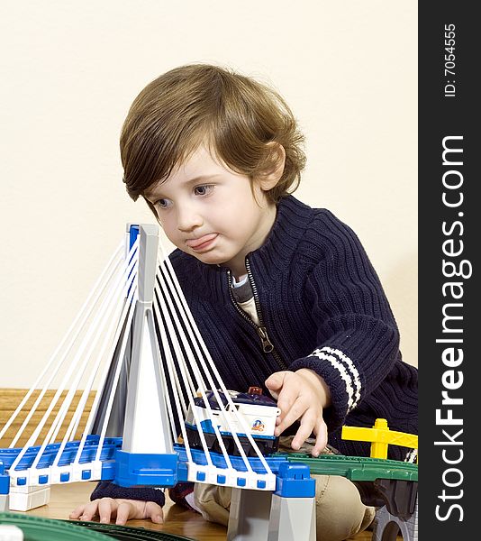 Little boy playing with train set