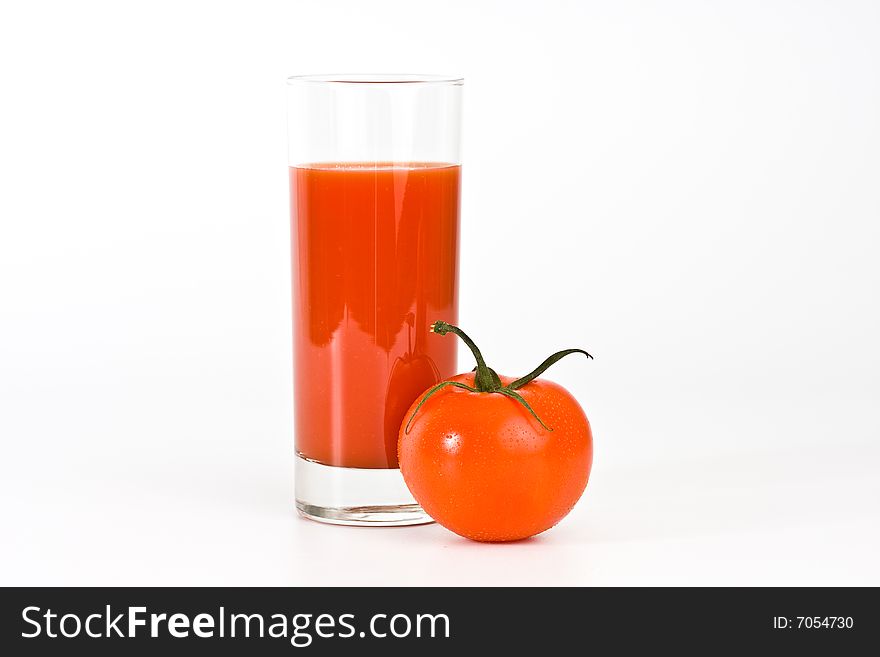 Glass of tomato juice and tomatoes.