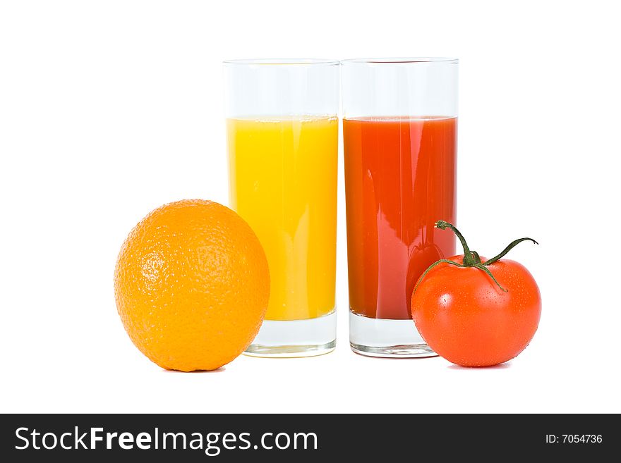 Orange and tomato fruits with juice in the glass