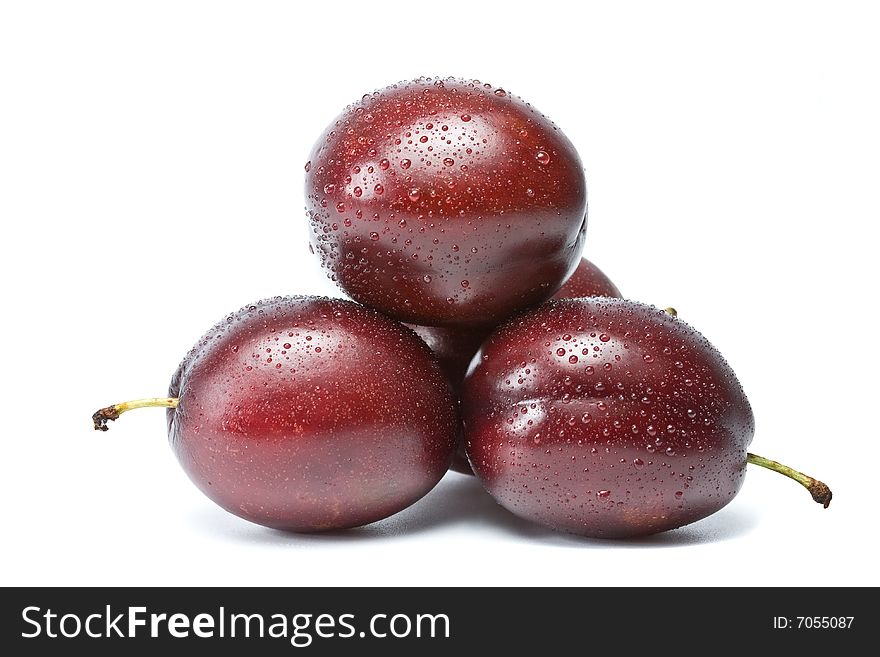 Three plums on a white background, isolation