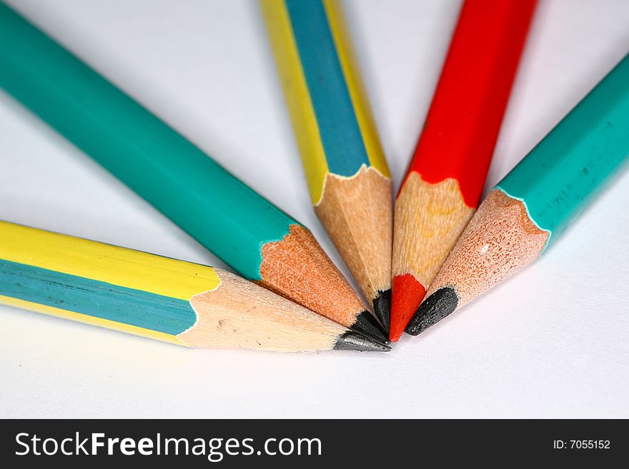 Closeup image of pencils laying on white paper
