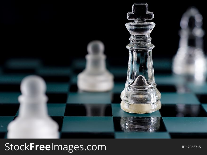A shot of a chessboard with focus on the king