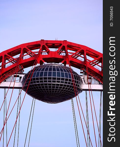 The red arch of the Moscow River suspension bridge in Moscow. The red arch of the Moscow River suspension bridge in Moscow