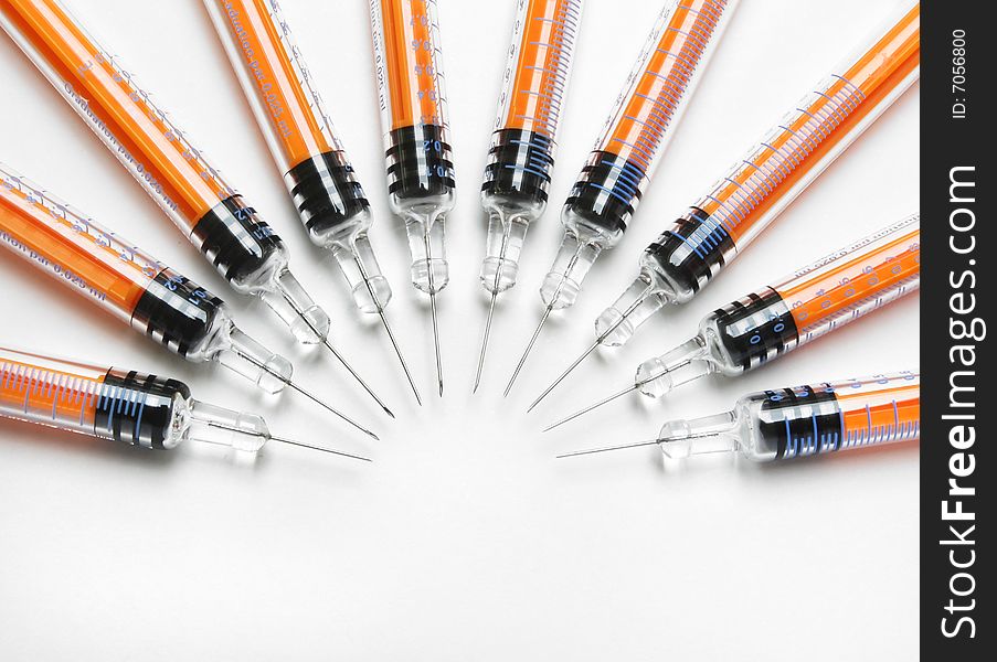 Orange syringes arranged in the semicircle