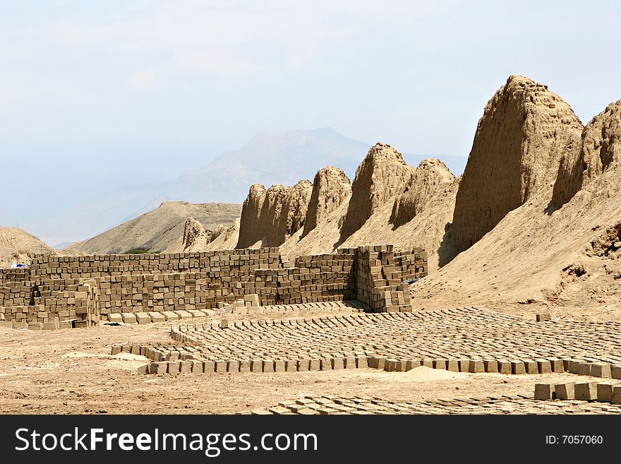 Hundred of traditionally made mud bricks are layed out in the hot desert sun to dry. Hundred of traditionally made mud bricks are layed out in the hot desert sun to dry