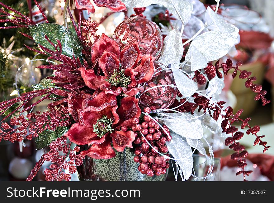 A christmas arrangement with lots of glitz and a poinsetta. A christmas arrangement with lots of glitz and a poinsetta