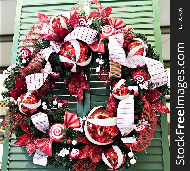 A red and white christmas wreath with ornaments