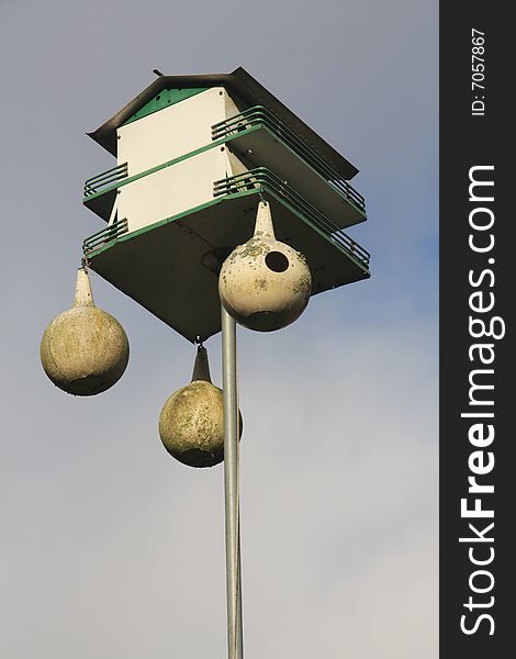 Double decker birdhouse with smaller hanging nests. Double decker birdhouse with smaller hanging nests