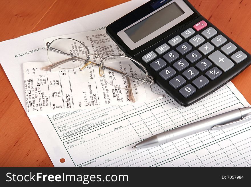 Financial concept with calculator, glass,pen and bill