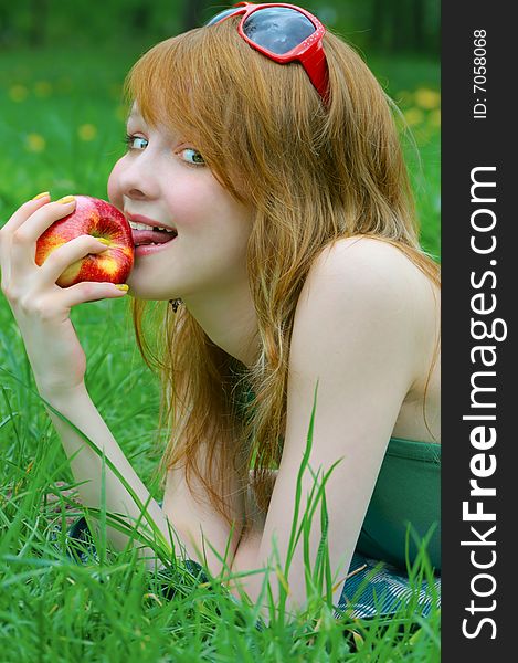 Pretty girl with apple outdoor
