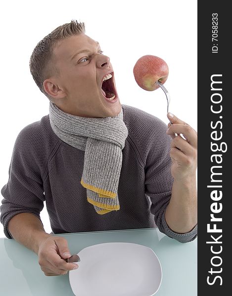 Man holding apple with fork on an isolated background