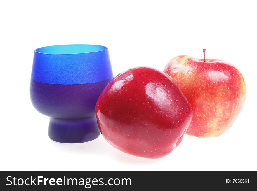 Two ripe red apple with blue glass. Two ripe red apple with blue glass