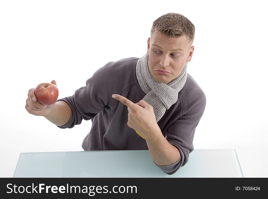 Young male pointing the apple on an isolated background