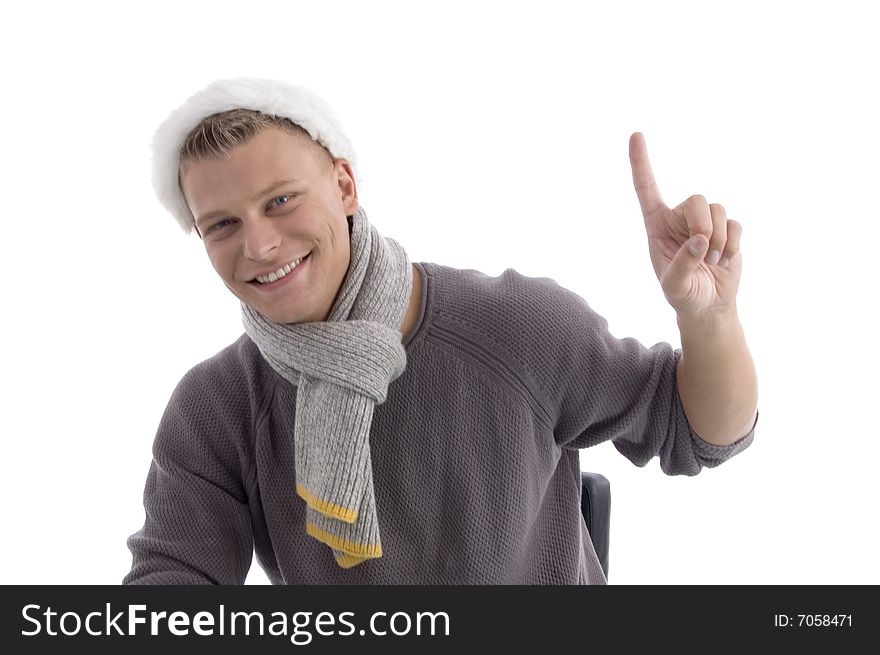 Smiling young male with Christmas hat indicating upside on an isolated background