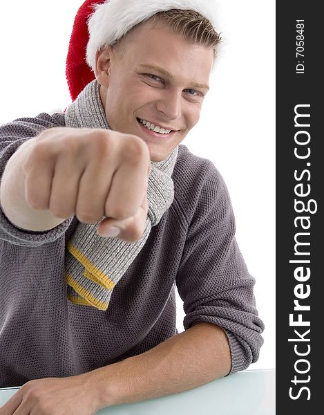 Smiling young man with Christmas hat showing punch on an isolated background